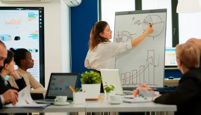 focused-team-leader-presenting-marketing-plan-interested-multiracial-coworkers-serious-speaker-boss.webp